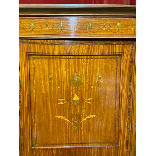 209 - A Late Victorian/Early Edwardian triple wardrobe, Designed with various inlaid panels and trims. Cen... 