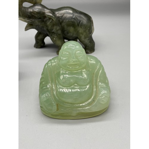 100 - A Lot of three Chinese hand carved Jade and Spinach Jade figurines. Includes Laughing buddha, Old ge... 