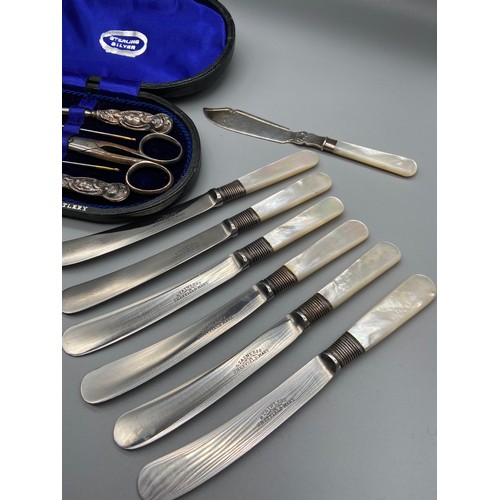 103 - A Silver handle manicure set within a fitted case [scissors & needles not silver] Together with a se... 