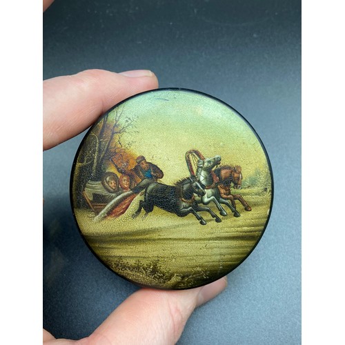 153A - A 19th century Russian Paper mache snuff box. Designed with a hand painted lid depicting three horse... 