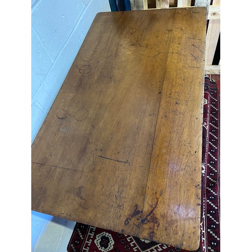 82A - A 19th century mahogany farmhouse dining table. Designed on turned leg supports and brass castor fee... 