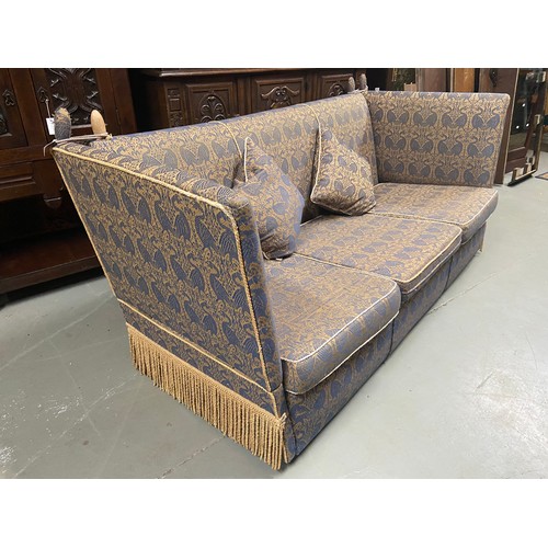 112A - A large Antique knole sofa. Upholstered with a gilt and blue bird design material. A piece from Libe... 