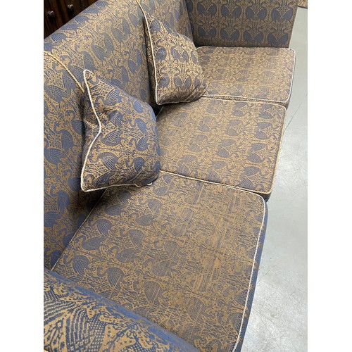 112A - A large Antique knole sofa. Upholstered with a gilt and blue bird design material. A piece from Libe... 