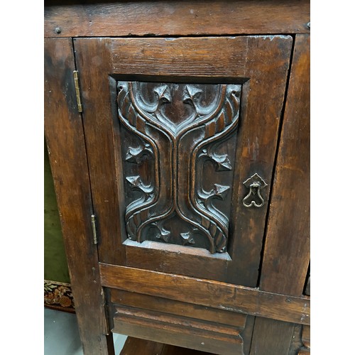 106B - A 17th century style oak buffet cupboard. Designed with two carved panel doors and single under draw... 