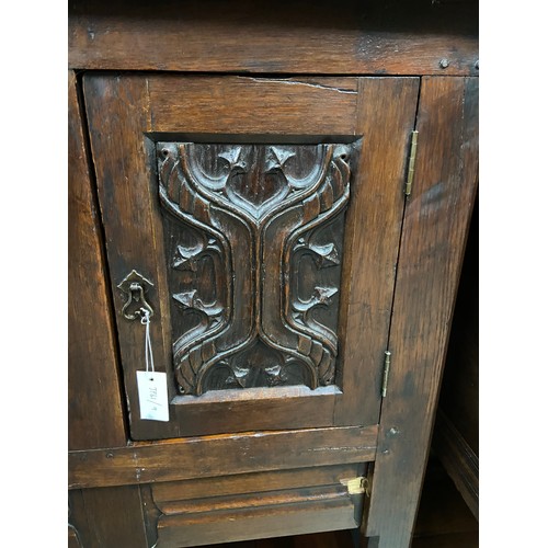 106B - A 17th century style oak buffet cupboard. Designed with two carved panel doors and single under draw... 