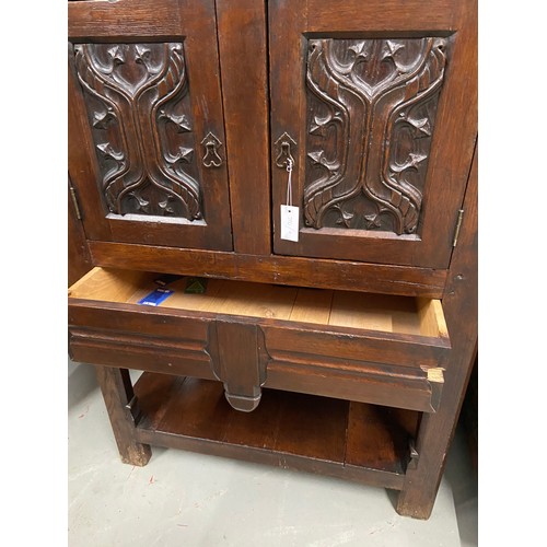 106B - A 17th century style oak buffet cupboard. Designed with two carved panel doors and single under draw... 