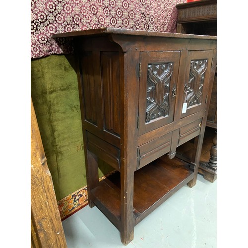 106B - A 17th century style oak buffet cupboard. Designed with two carved panel doors and single under draw... 