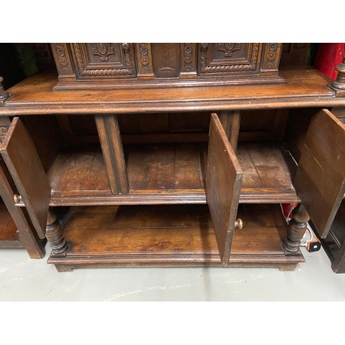 105B - An Impressive 17th Century style oak court cupboard unit. Showing detailed carved panel doors and tr... 