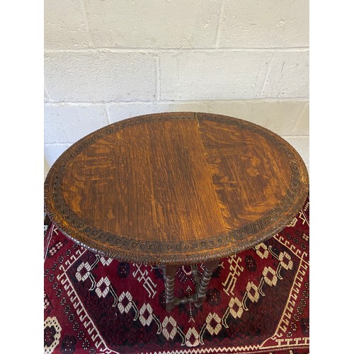 88A - An early 20th century oval drop end kitchen table, Carved trims and bobble designed legs. [66cm heig... 