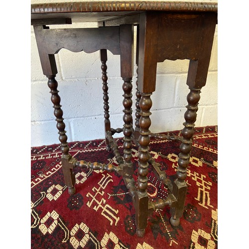 88A - An early 20th century oval drop end kitchen table, Carved trims and bobble designed legs. [66cm heig... 