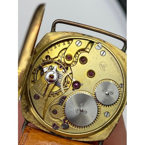 70J - An Antique 18ct gold cased gent's wrist watch fitted with a brown leather strap.