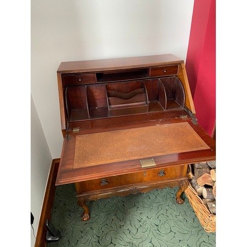 321W - An Antique three drawer writing bureau designed with ball and claw feet.