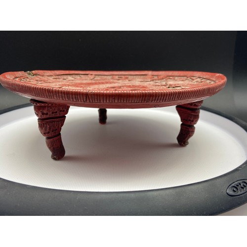 161J - A Chinese Cinnabar lidded box containing an ink stone, together with an antique three foot pedestal ... 