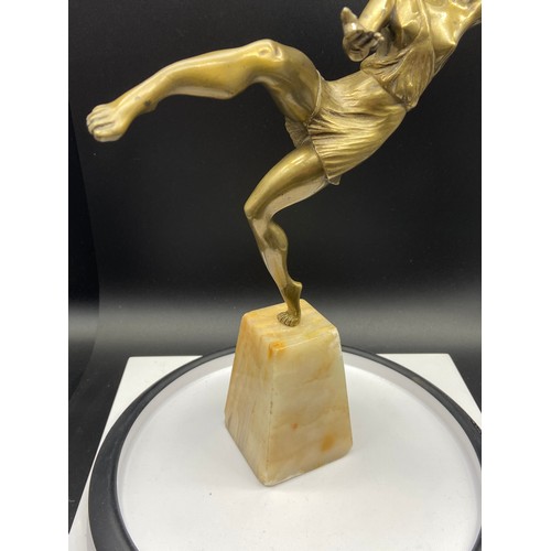 134J - An Art Deco gilt bronze dancing semi nude lady figurine. Displayed upon an alabaster base. Signed Va... 