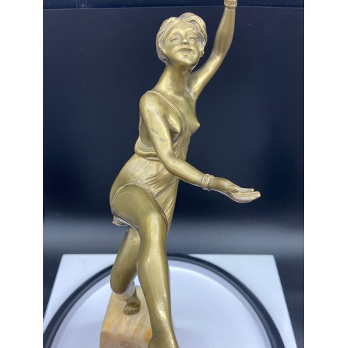 134J - An Art Deco gilt bronze dancing semi nude lady figurine. Displayed upon an alabaster base. Signed Va... 