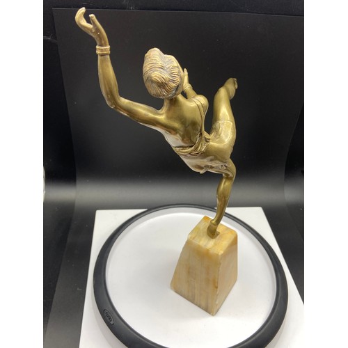 134J - An Art Deco gilt bronze dancing semi nude lady figurine. Displayed upon an alabaster base. Signed Va... 