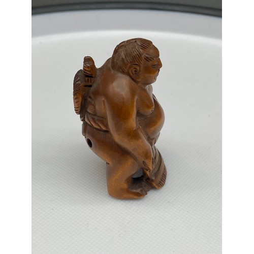 126J - A Japanese hand carved netsuke of a sumo wrestler, signed. [5cm in height]