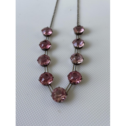 16J - A vintage white metal art deco necklace fitted with 9 large pink cut stones [length 35cm]