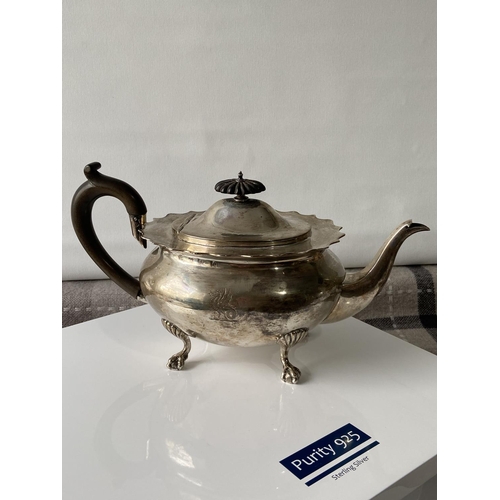 187J - A Birmingham silver teapot supported on claw & ball feet, engraved to the side showing a dragon insi... 