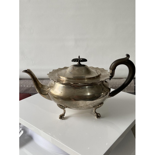 187J - A Birmingham silver teapot supported on claw & ball feet, engraved to the side showing a dragon insi... 