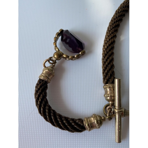 58J - A 19th century albert chain made from braided hair, gilt metal attachments and amethyst & gilt metal... 