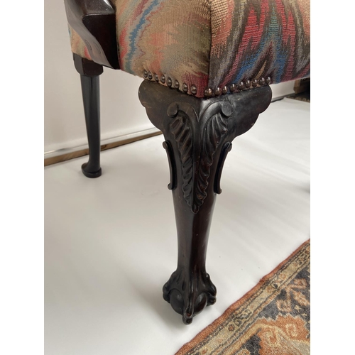 62 - A 19th century carver arm chair, supported on claw and ball feet. [back 95cm] [seat area 47cm]