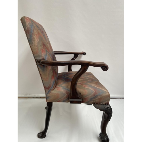 62 - A 19th century carver arm chair, supported on claw and ball feet. [back 95cm] [seat area 47cm]