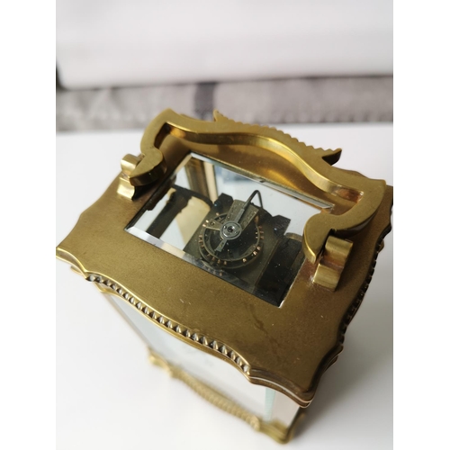 30J - An Antique heavy brass and glass carriage clock. In a working condition with key. [12x8x6.5cm]