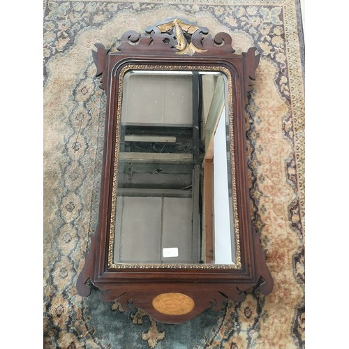 9 - A Georgian bevel edged and giltwood trim wall mirror with a pierced and carved wood extension to the... 