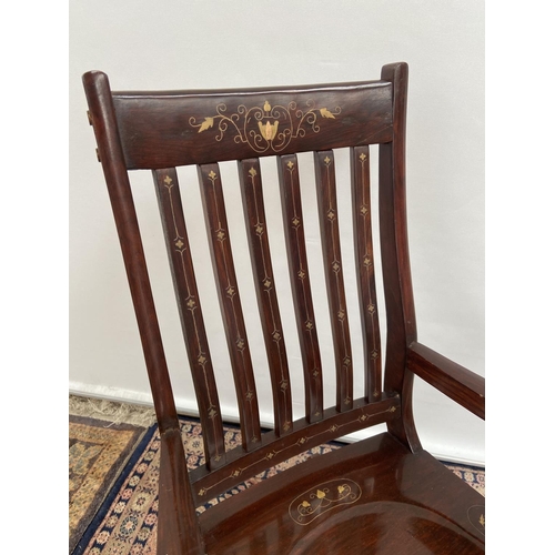 19 - A Hardwood and brass inlaid rocking arm chair. [80x50x40cm] Originally from Saudi Arabia.