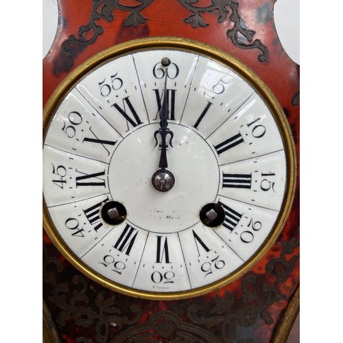 45 - An Antique French Boulle clock. Designed with tortoise shell and brass inlays. Rack French make. Run... 