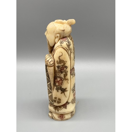 67J - An early 20th century Japanese bone carved gentleman figure. Figure is holding a sweeping brush in h... 