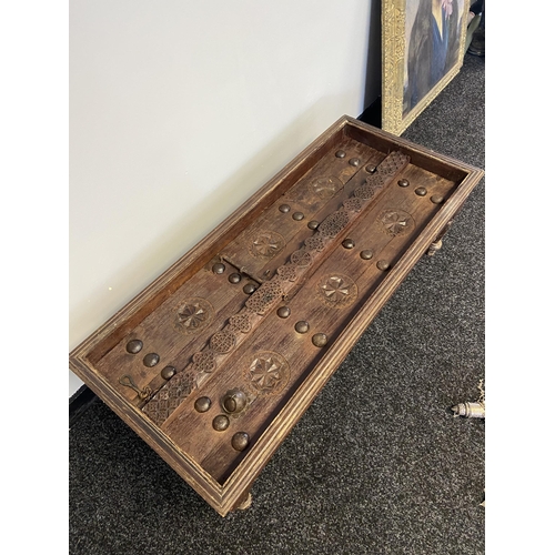 18 - An original Saudi Arabia door made into a coffee table. [41x120x52cm]