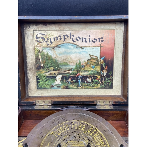 154 - An Antique Schutz- Marke German Symphonia music box. Comes with various music discs and handle. In a... 