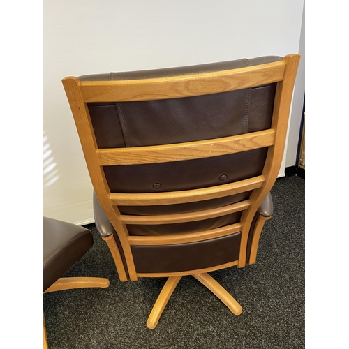 160 - An Ercol brown leather and light wood relaxer arm chair with matching stool.