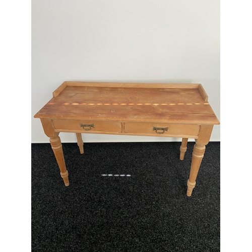 185 - A 19th century pine two drawer console table. Designed on turned legs