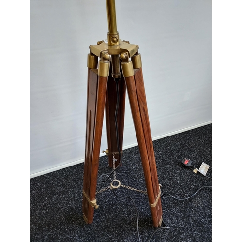 242 - A Contemporary wood and brass tripod floor lamp. [In a working order]