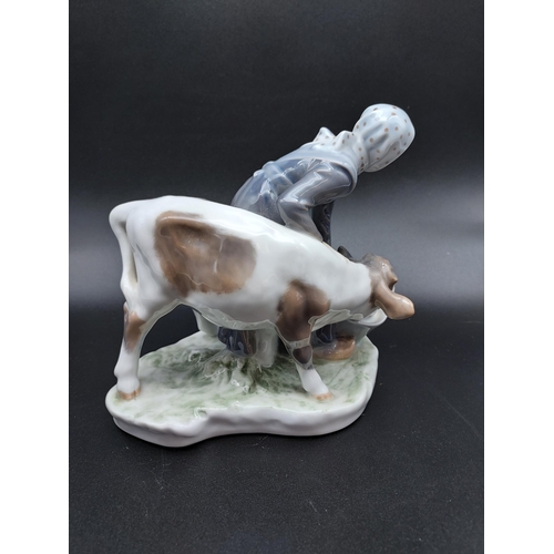 258 - A Royal Copenhagen figurine Girl with Calf. [16cm in height]