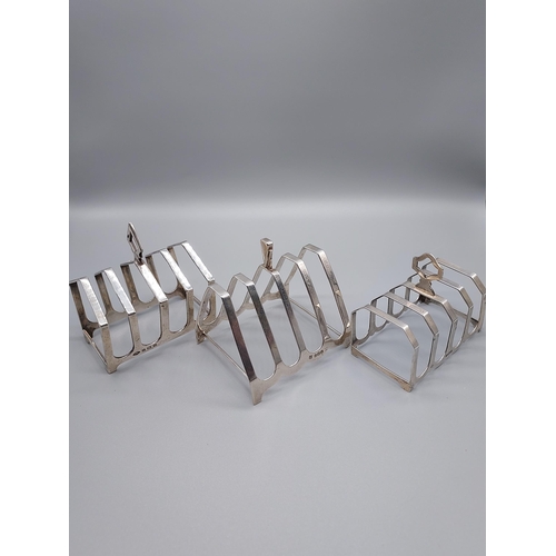 54J - A Lot of three Birmingham silver four slice toast racks.