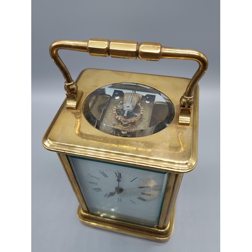 64J - A Heavy Antique brass and bevel glass carriage clock. Comes with a key. [Runs for a short while then... 