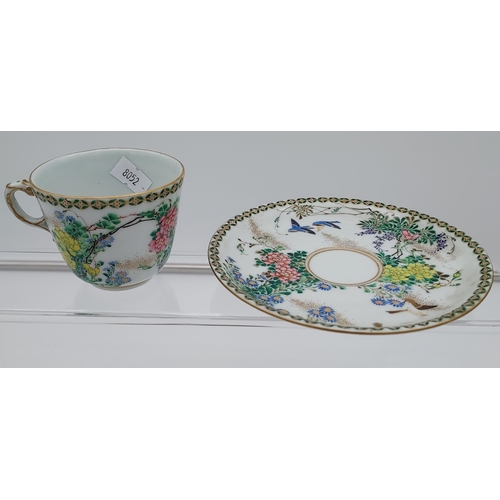 96 - A 19th century Chinese cup and saucer, hand painted with flowers and birds.