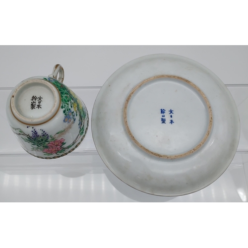 96 - A 19th century Chinese cup and saucer, hand painted with flowers and birds.