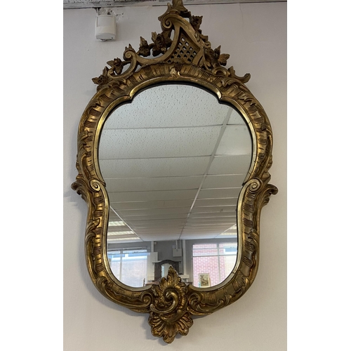 114 - A 18th/ 19th century ornate gilt carved framed wall mirror. [97x50cm]