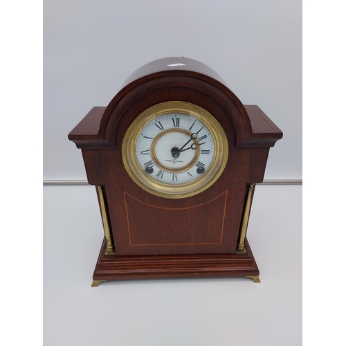 119 - An Edwardian mahogany cased mantle clock. In a working condition [34cm in height]