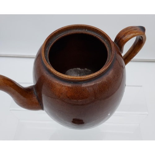 95 - A Scottish brown glaze tea pot. [19cm in height]