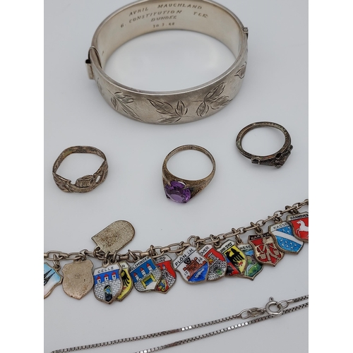 530 - Birmingham silver bangle, silver and enamel souvenir charm bracelet, three silver rings and silver p... 