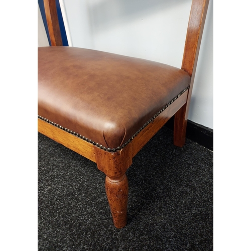 186 - A 19th century window two seat loving chair. Reupholstered in brown leather [80x76x30cm]