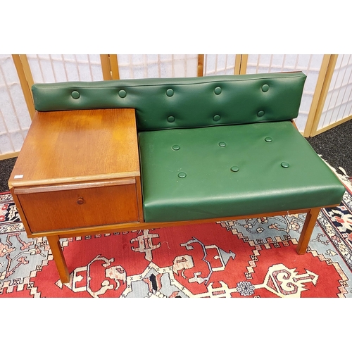 202 - A Mid century teak and faux green leather telephone table. [56x98x50cm]