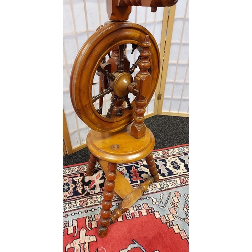 206 - A Victorian arts and crafts bobble leg spinning wheel. [135cm in height]