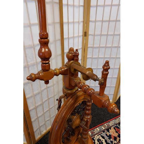 206 - A Victorian arts and crafts bobble leg spinning wheel. [135cm in height]